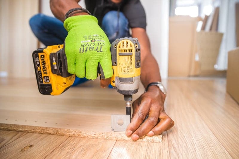 Handyman using a power drill for furniture assembly