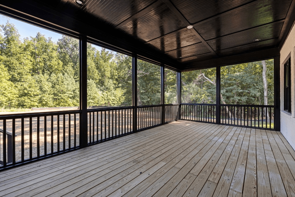 Screened porch with wood deck flooring and railings